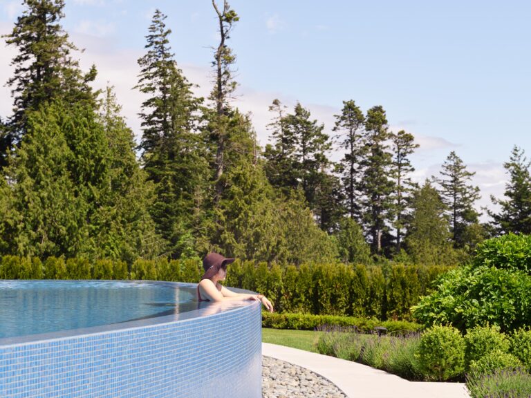 woman in pool overlooking view of Georgia Strait by Teragon